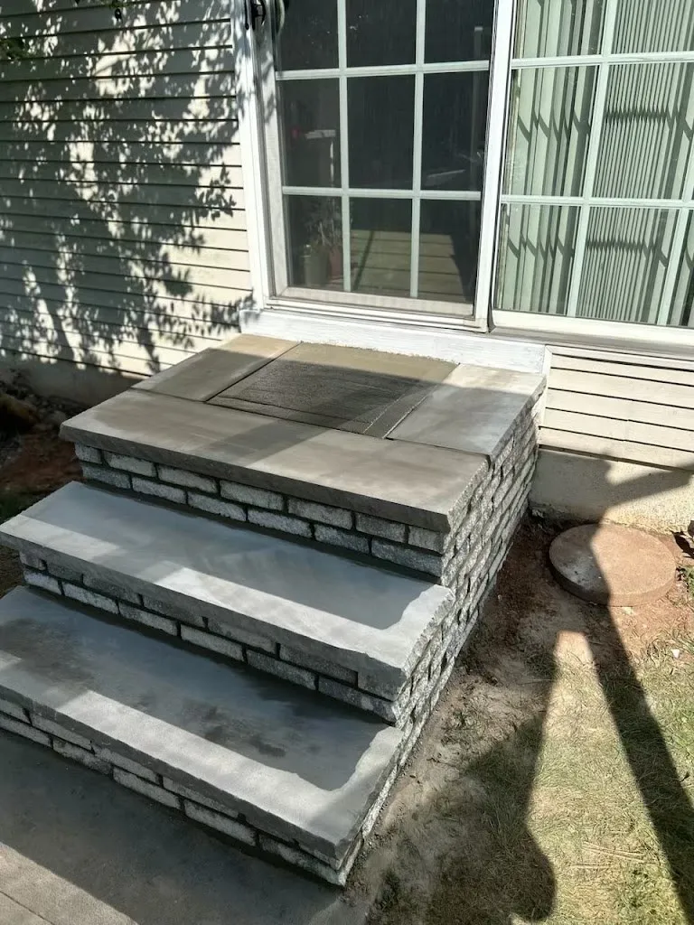 Bluestone steps with stacked stone risers at a side door