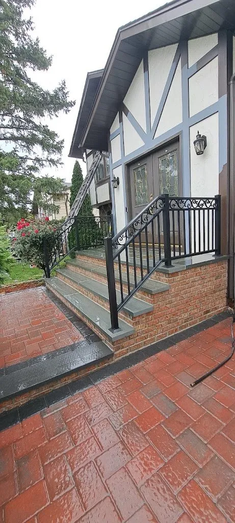 Red brick paver walkway to new steps at a Tudor-style home