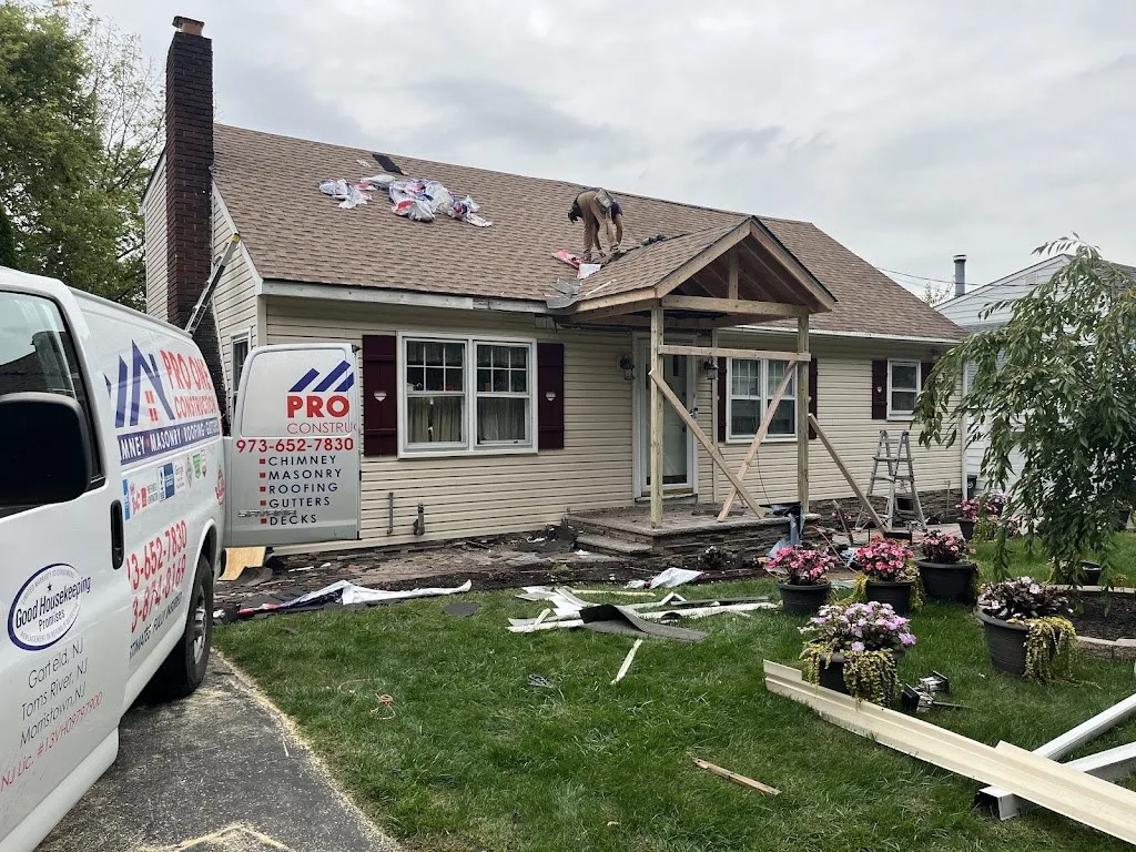 Crew installing roofing over a new front porch