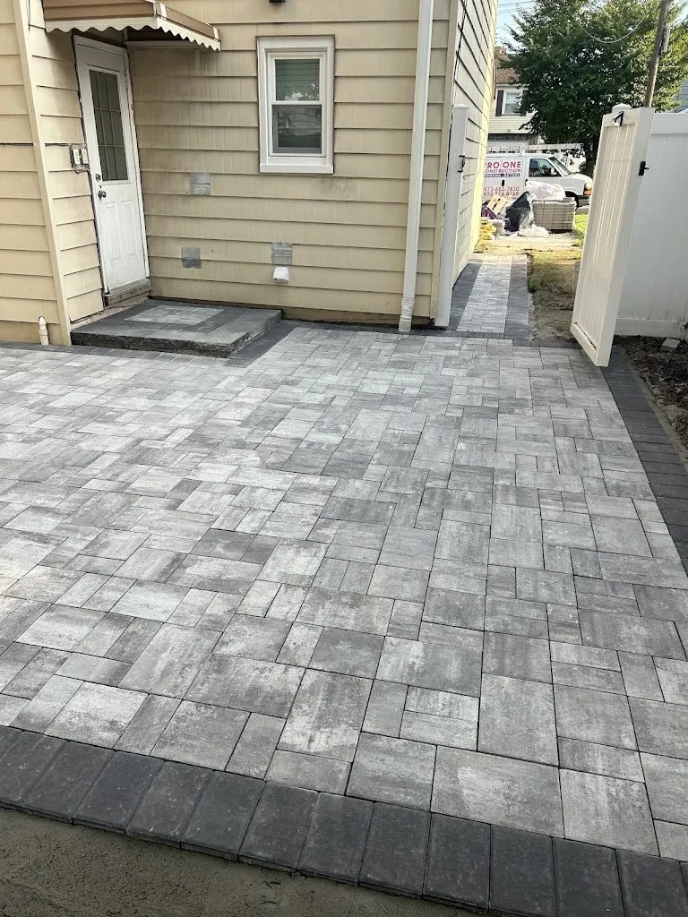 Gray paver patio and landing outside a back door
