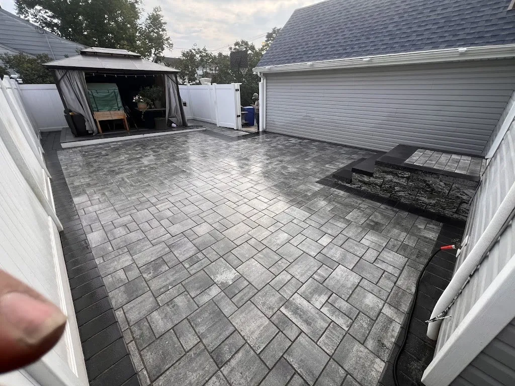Gray paver patio with gazebo and stone seating wall