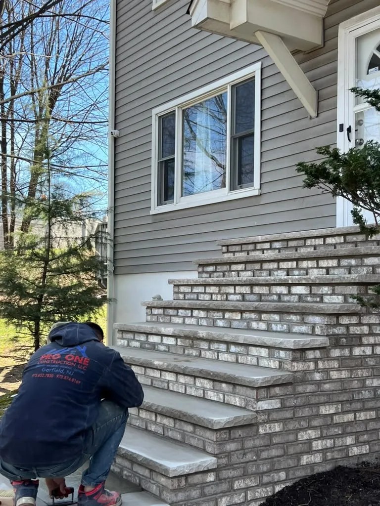 Pro One mason pointing a tall set of new brick front steps
