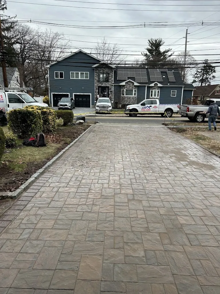 Long tumbled paver driveway leading from the house to the street