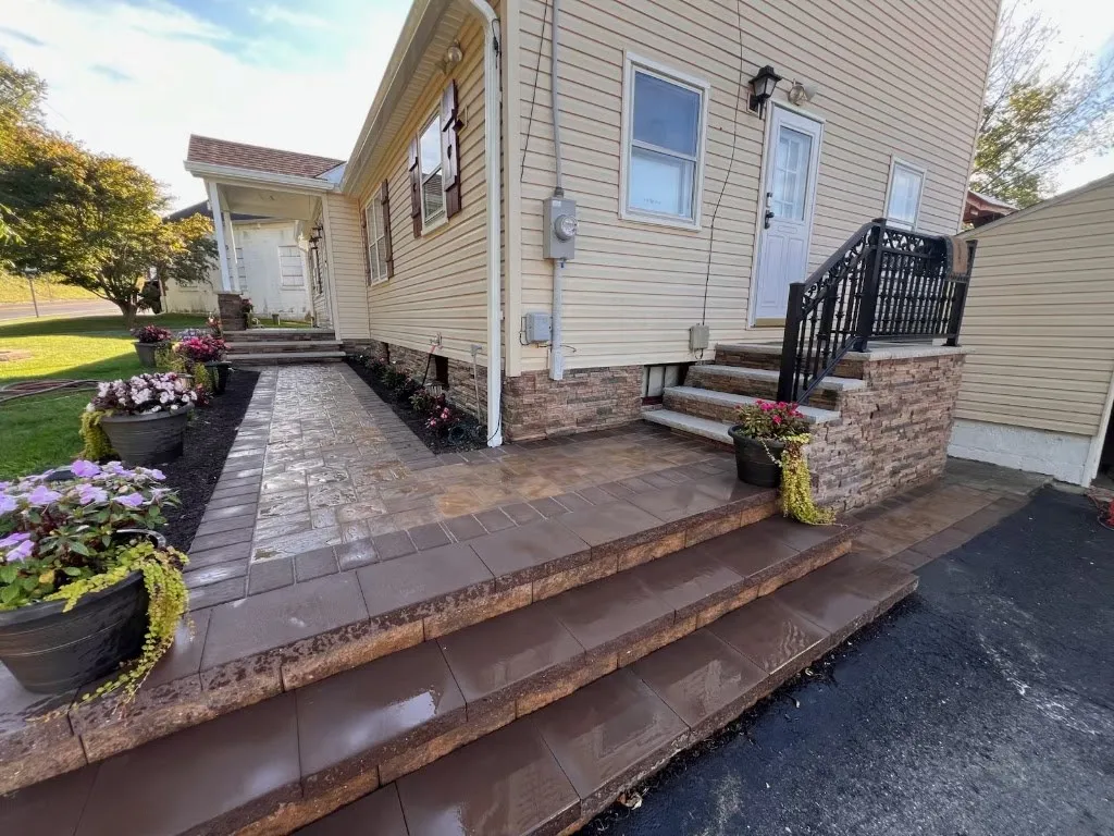 Wide paver steps and landing with stone veneer and planters