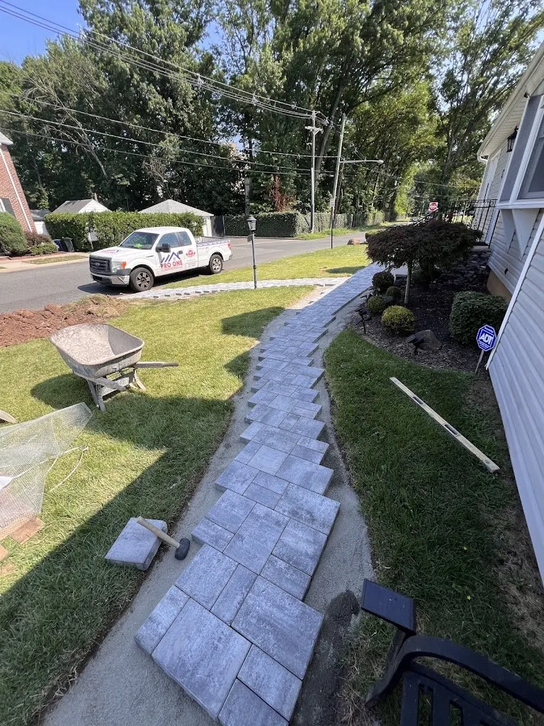 Paver walkway being installed along a lawn