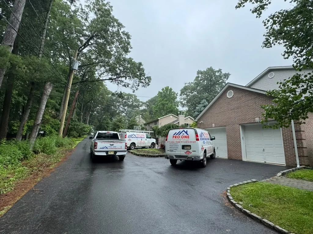Pro One trucks on a wooded driveway at a job site