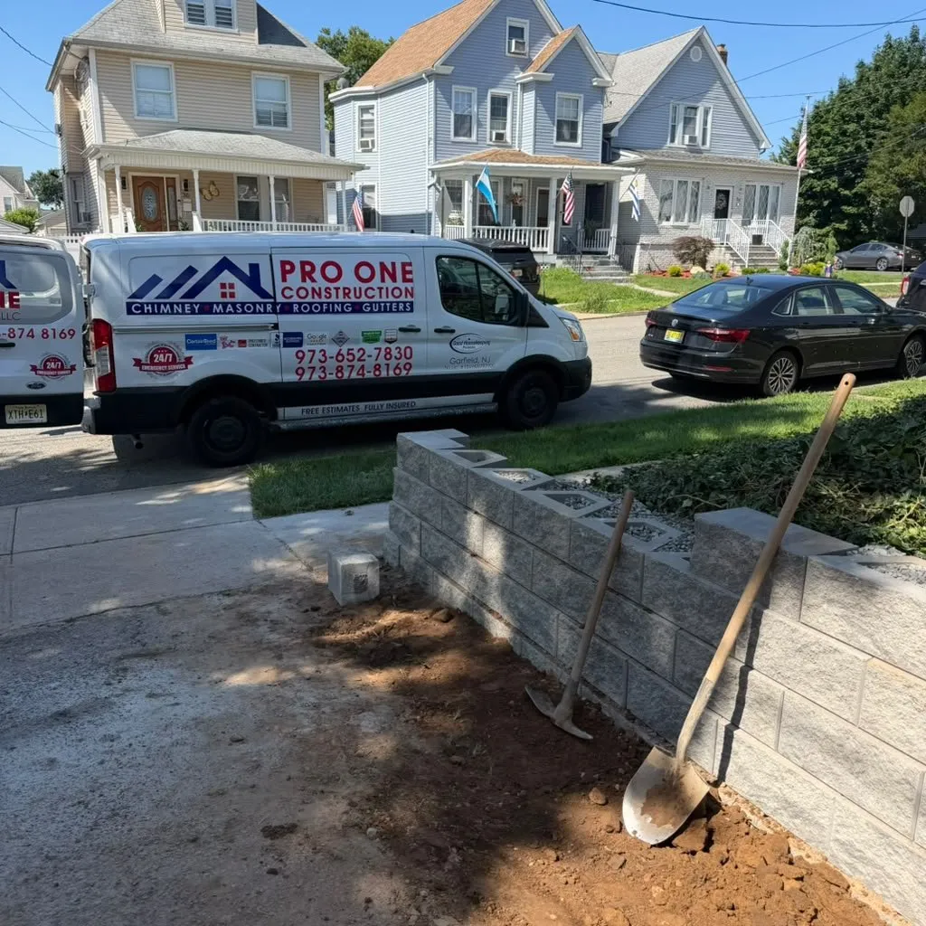Pro One van parked at a job building a block wall in front of a home