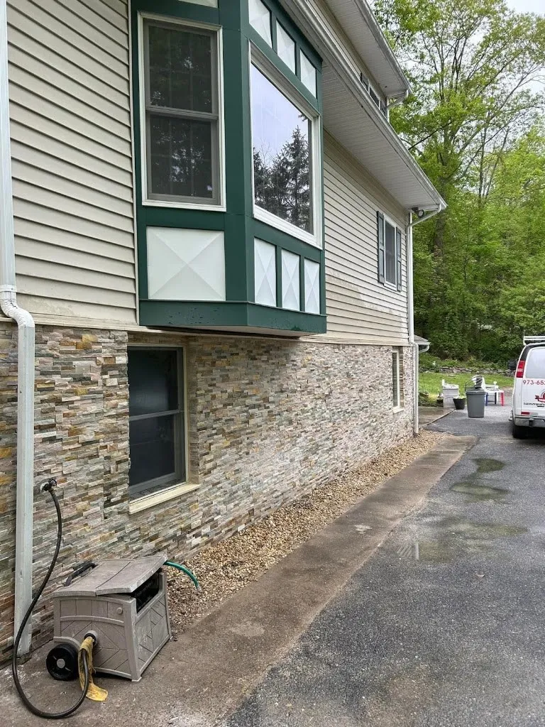Stacked stone veneer covering a home foundation wall